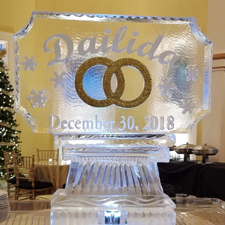 Wedding ice sculpture featuring engraved rings and names David and Lisa