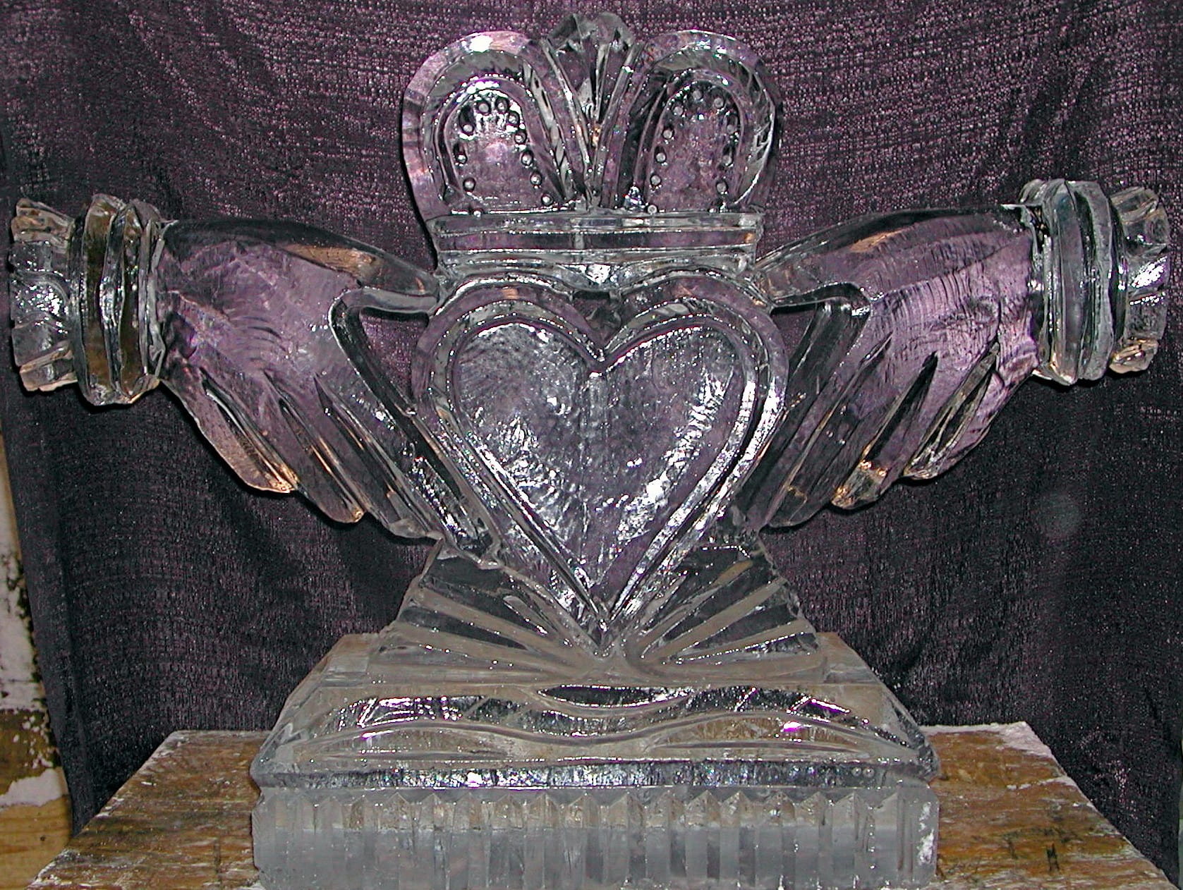 Heart-shaped wedding ice sculpture with crown and rings